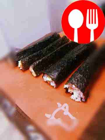 Wet the long edge of the sheet with water,...