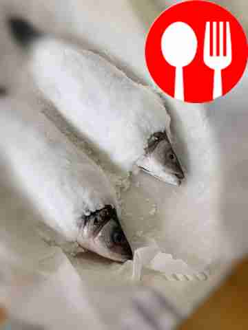 Place the fish on top of the salt, and top...