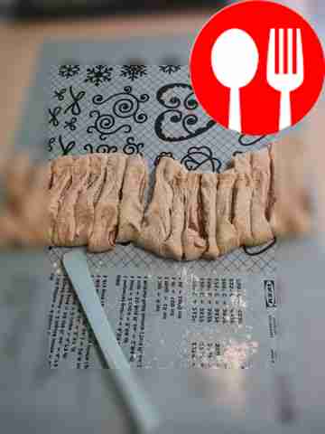 Roll out the dough a little and cut it into an...