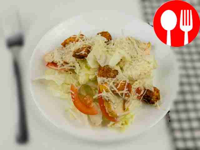 Season the salad with Caesar dressing and mix...