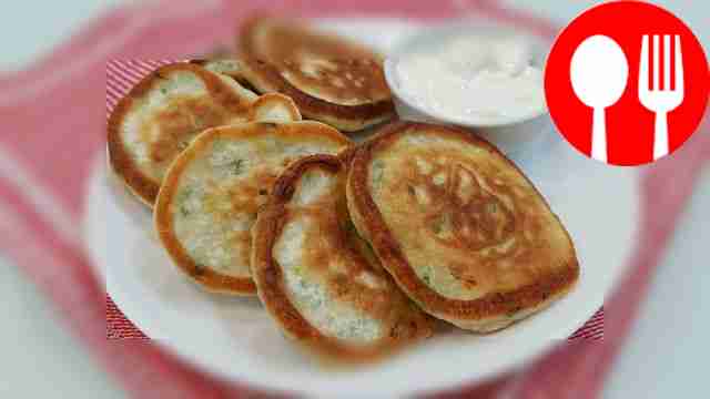 Lush pancakes with green onions on kefir