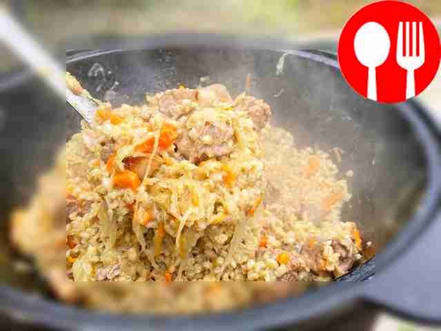 Beef with pearl barley and sauerkraut in a cauldron