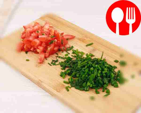 On a cutting board, finely chop the tomato and...