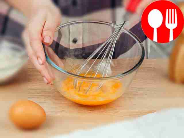 In a bowl, beat two eggs with a whisk.