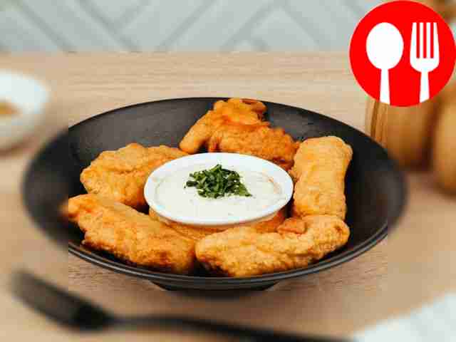 Serve salmon in batter with sour cream and herbs sauce.