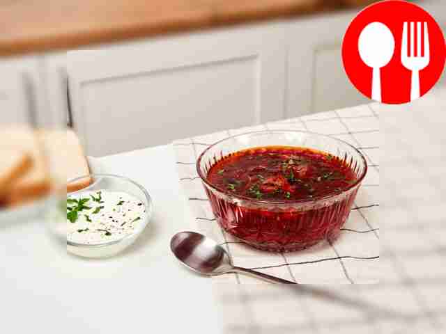 Pour a portion of borscht with chicken into a...
