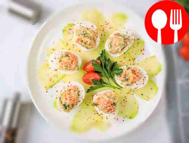 Place the deviled eggs on a plate and garnish...