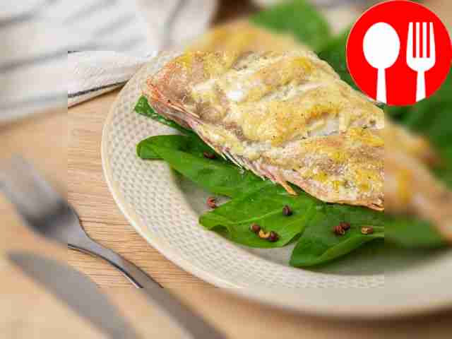 Perch on a baking sheet in mayonnaise with garlic