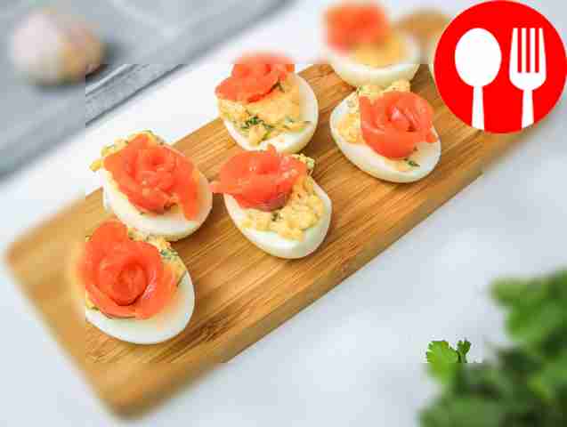 Place eggs stuffed with salmon on a large flat...