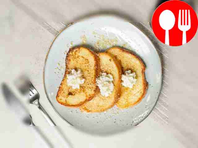 Top toast with toasted almonds with whipped cream.