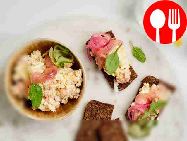 Garnish fish salad with rice and egg with a...