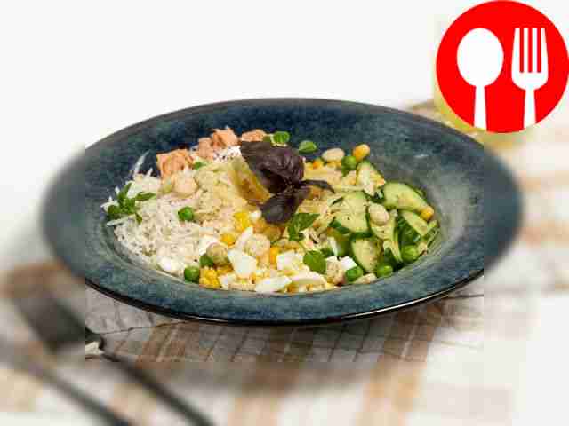 Salad with canned fish, eggs, rice and cucumber