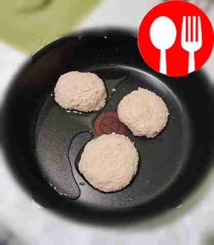 With wet hands, form cheesecakes and place in...