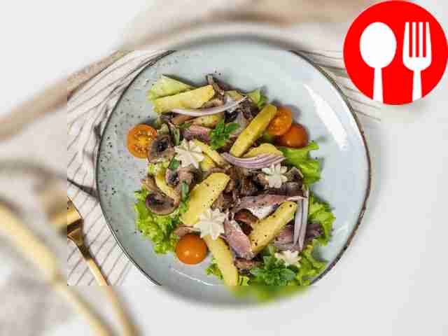 Garnish the fish and potato salad with a sprig...