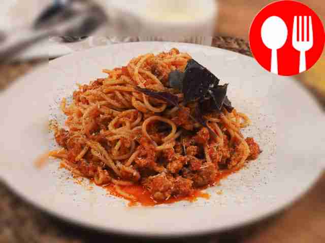 To serve, place spaghetti on a plate and top...