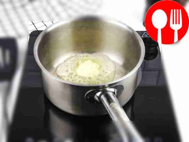 Heat a saucepan or ladle with a piece of butter.