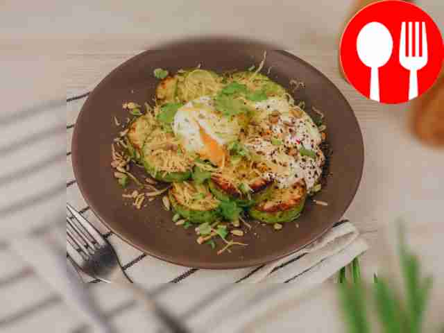 Place the zucchini on a plate. Place a poached...