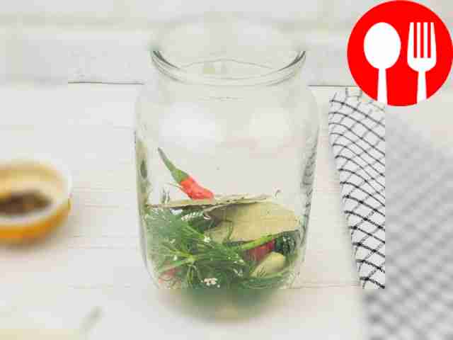 Place bay leaf, chili pepper, dill and a clove...