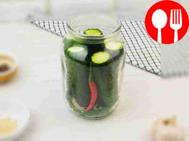Place the cucumbers in the preparation jar so...
