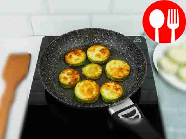 Place zucchini slices in a frying pan heated...