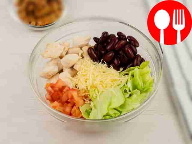 Add cheese, chopped tomatoes, lettuce and beans.