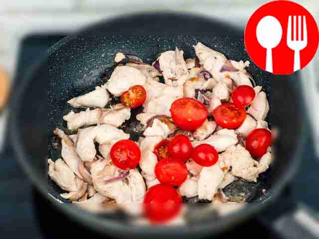 Add halved cherry tomatoes to the pan.