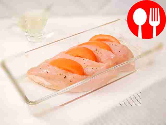 Cut the tomato into slices and place it into...