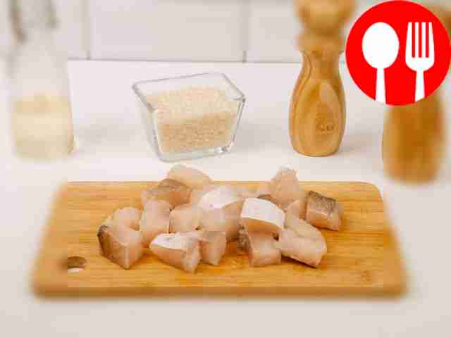 Using a knife, cut the fish fillet into large pieces.