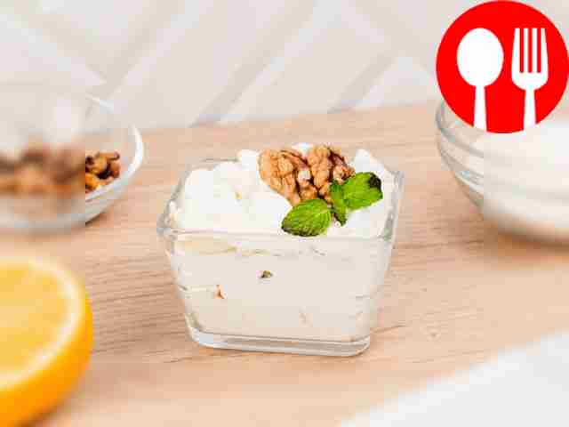Creamy dessert with meringue, sponge cake and banana