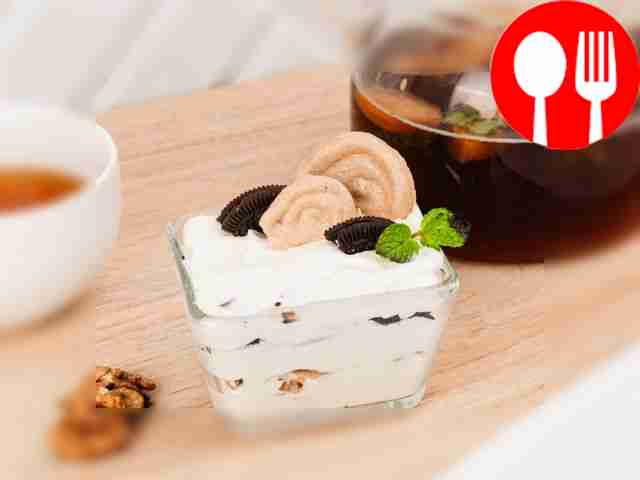 Creamy dessert with meringue, Oreo and nuts