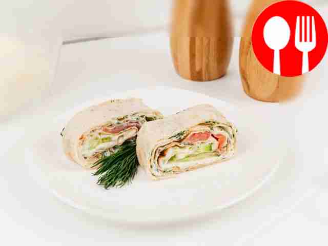 Roll with salmon, melted cheese and cucumber