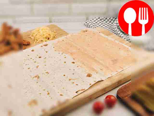 Assemble the roll. Place the pita bread on a...