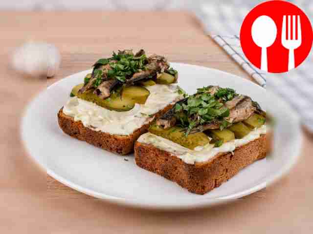 Sandwiches with sprats, eggs and pickled cucumbers