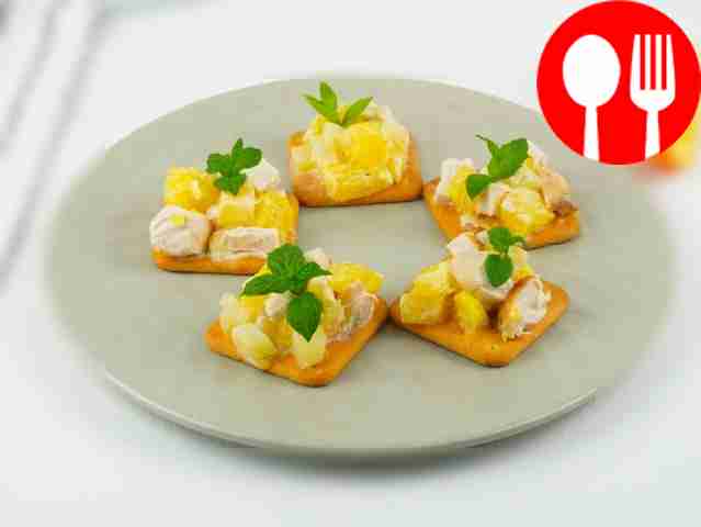 Canapes with chicken, pineapple and orange