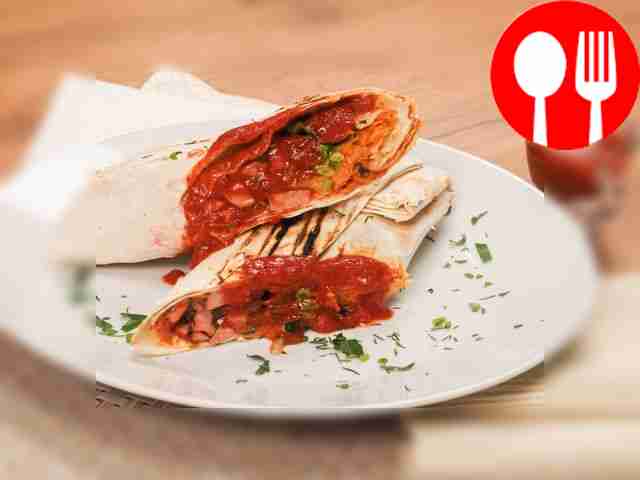 Shawarma of boiled sausage with Chinese cabbage and dried herbs