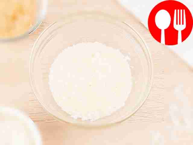 Mix condensed milk and coconut flakes in a container.