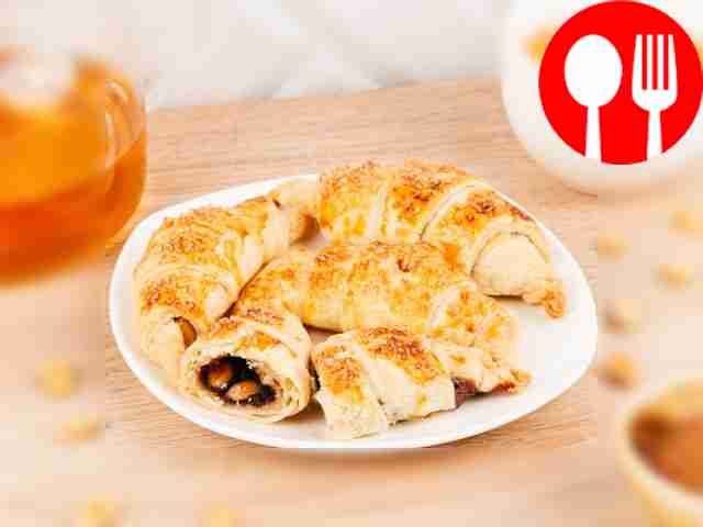 Croissants with condensed milk, cocoa and peanuts