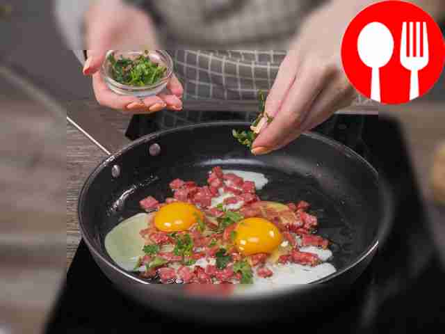 Make scrambled eggs. Cut the sausage in a...