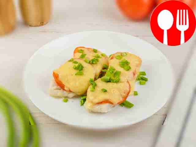 Pollock fillet baked with tomatoes and cheese