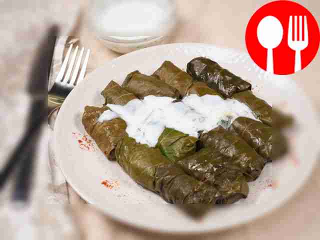 Stuffed cabbage rolls in grape leaves