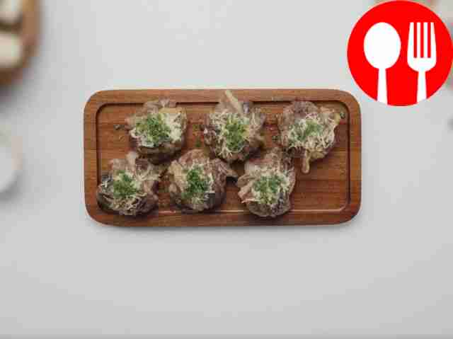 Champignons with garlic butter and cheese in bacon