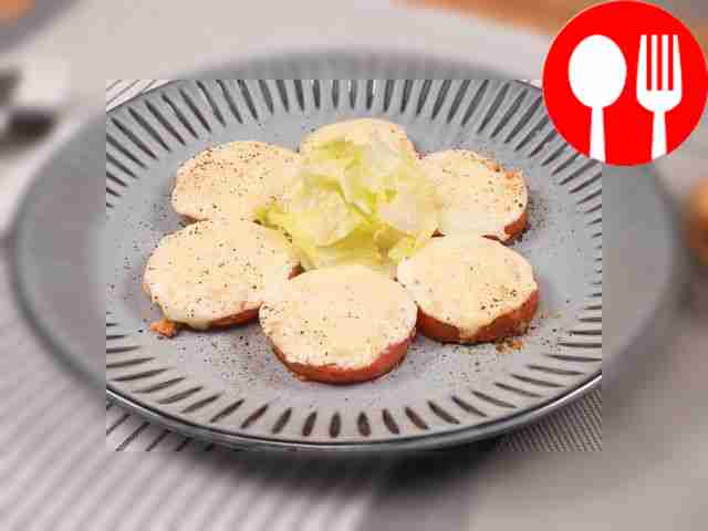 Fried tomatoes with cheese in a frying pan