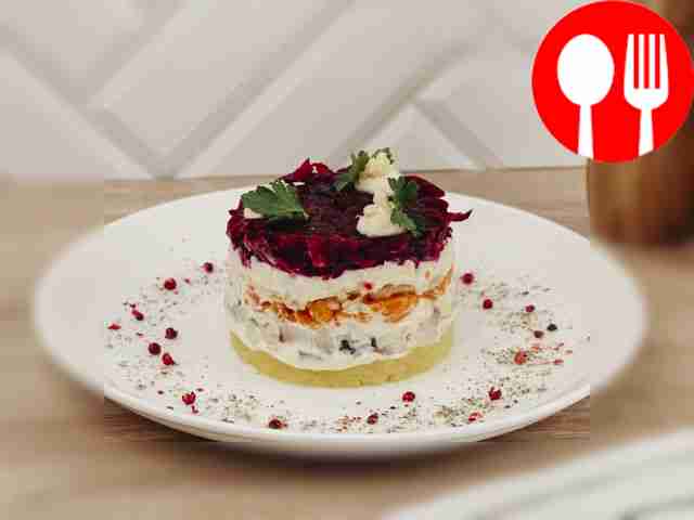 Herring under a fur coat with an apple