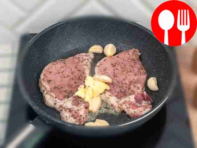 Add butter and garlic to the meat.