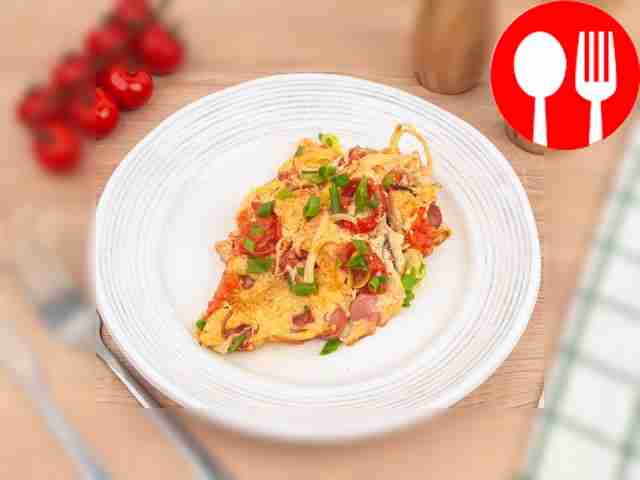 Omelette with sausages in a frying pan