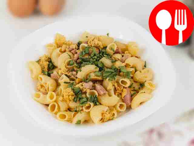 Pasta with sausages in a frying pan