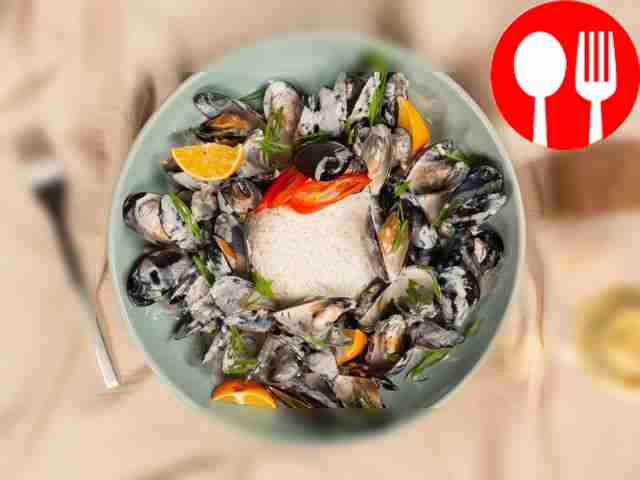 Serve the mussels in the creamy sauce with a...