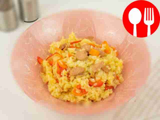 Rice with sausages in a frying pan