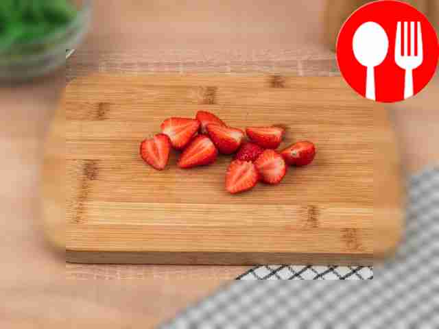 Remove the stems from the strawberries and cut...