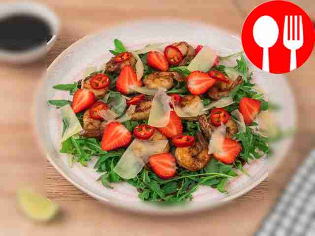 Place the arugula in a salad bowl and pour the...